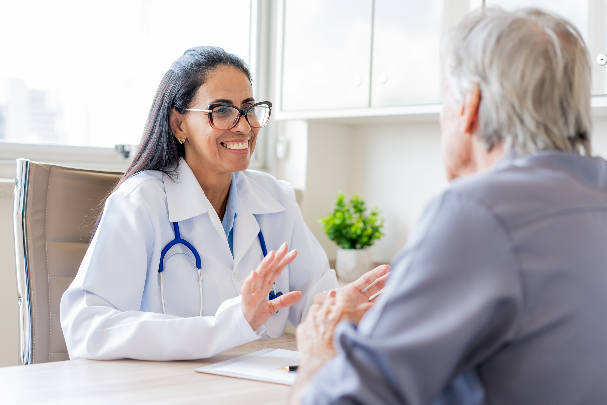 Doctor smiling while sitting at desk