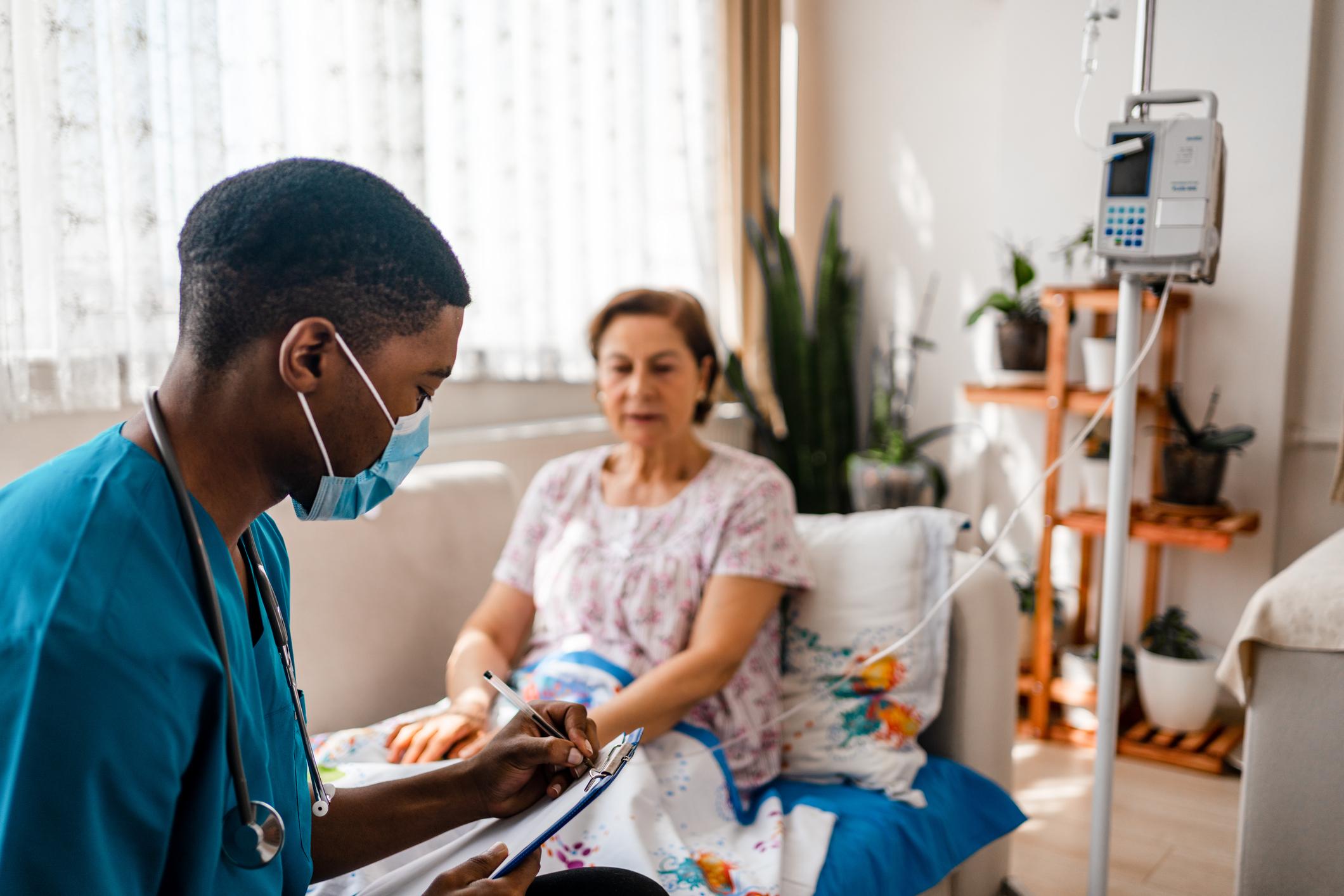 Patient and doctor doing healthcare treatment in a home